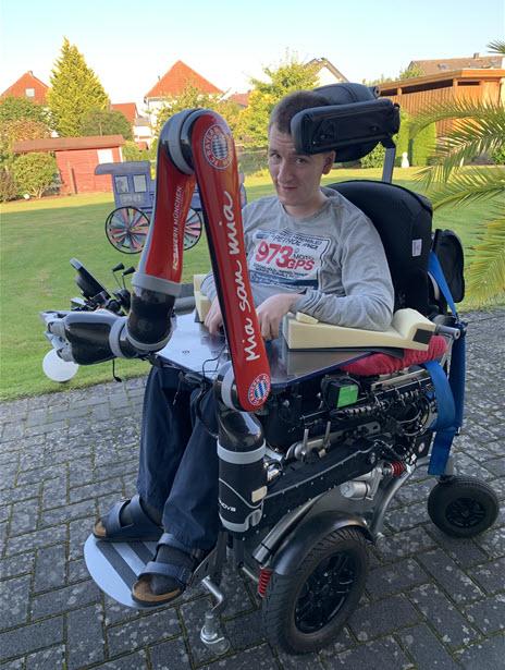 This is a picture of Hendrik, mo-vis user with Kinova robotic arm