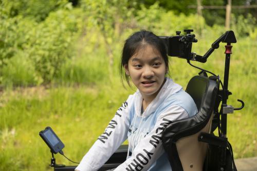 Lisa* in a power chair with Head Control